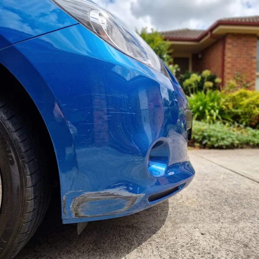 A kerb-scraped front bumper corner before repair