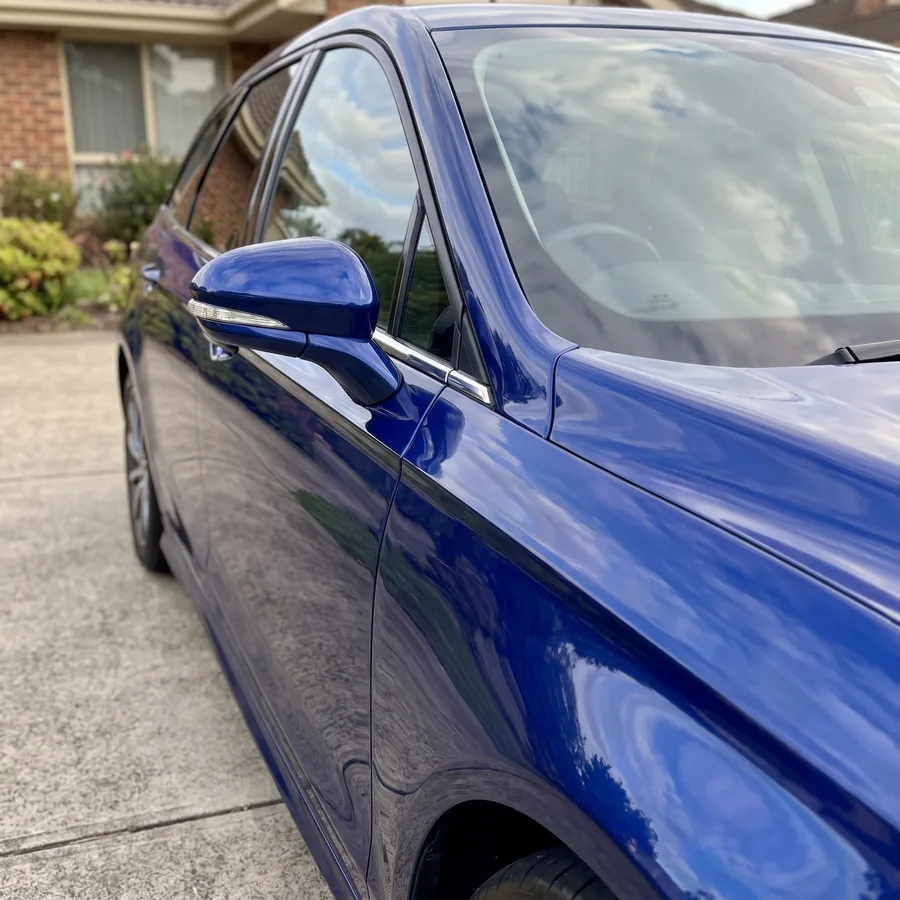 The same blue wagon front guard cut and polished to a deep gloss