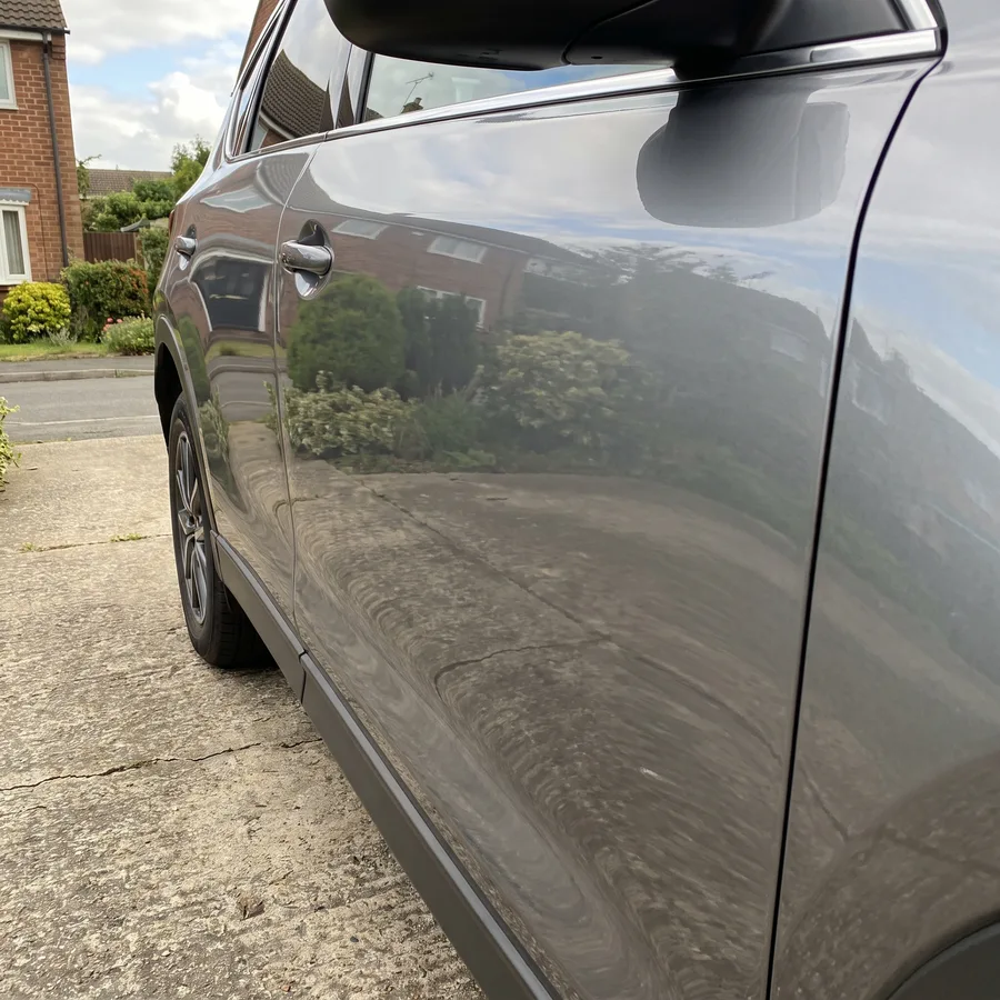 The same grey SUV rear door smoothed flat and refinished