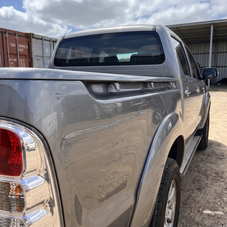 A grey ute rear tub scraped and rubbed dull, before the repair