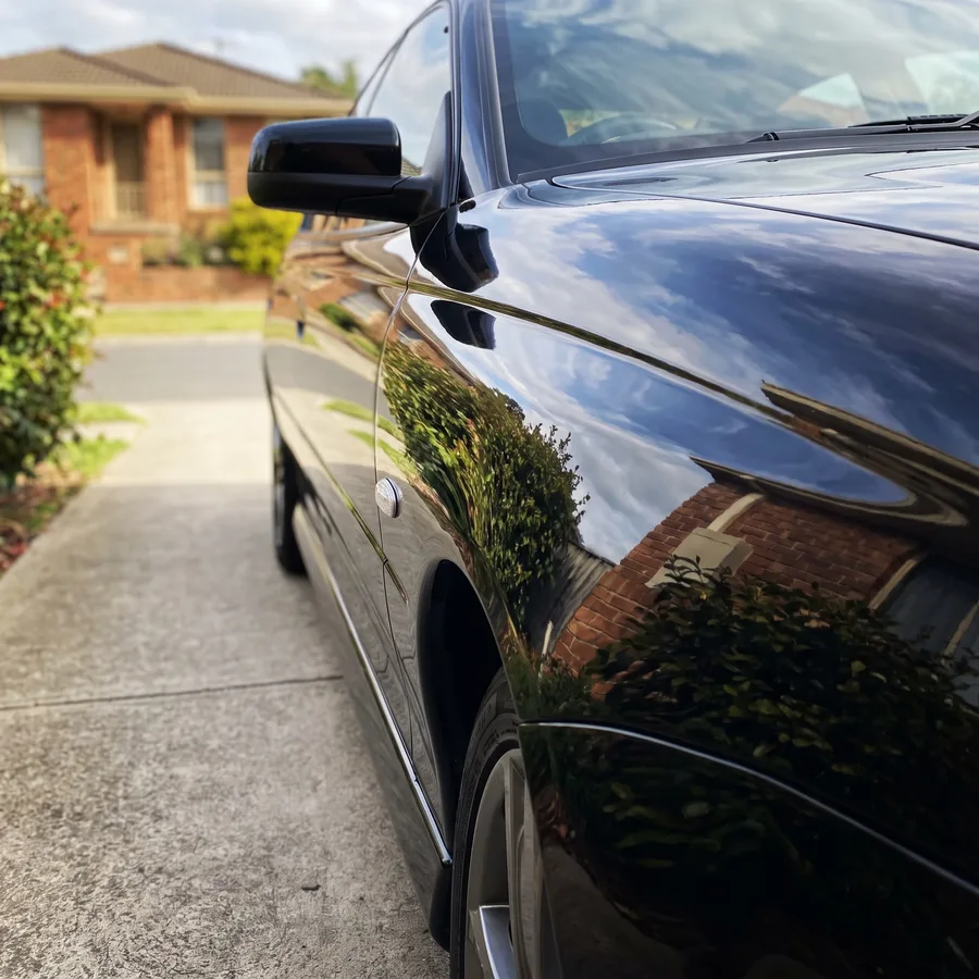The same black sedan bonnet sealed to a mirror gloss