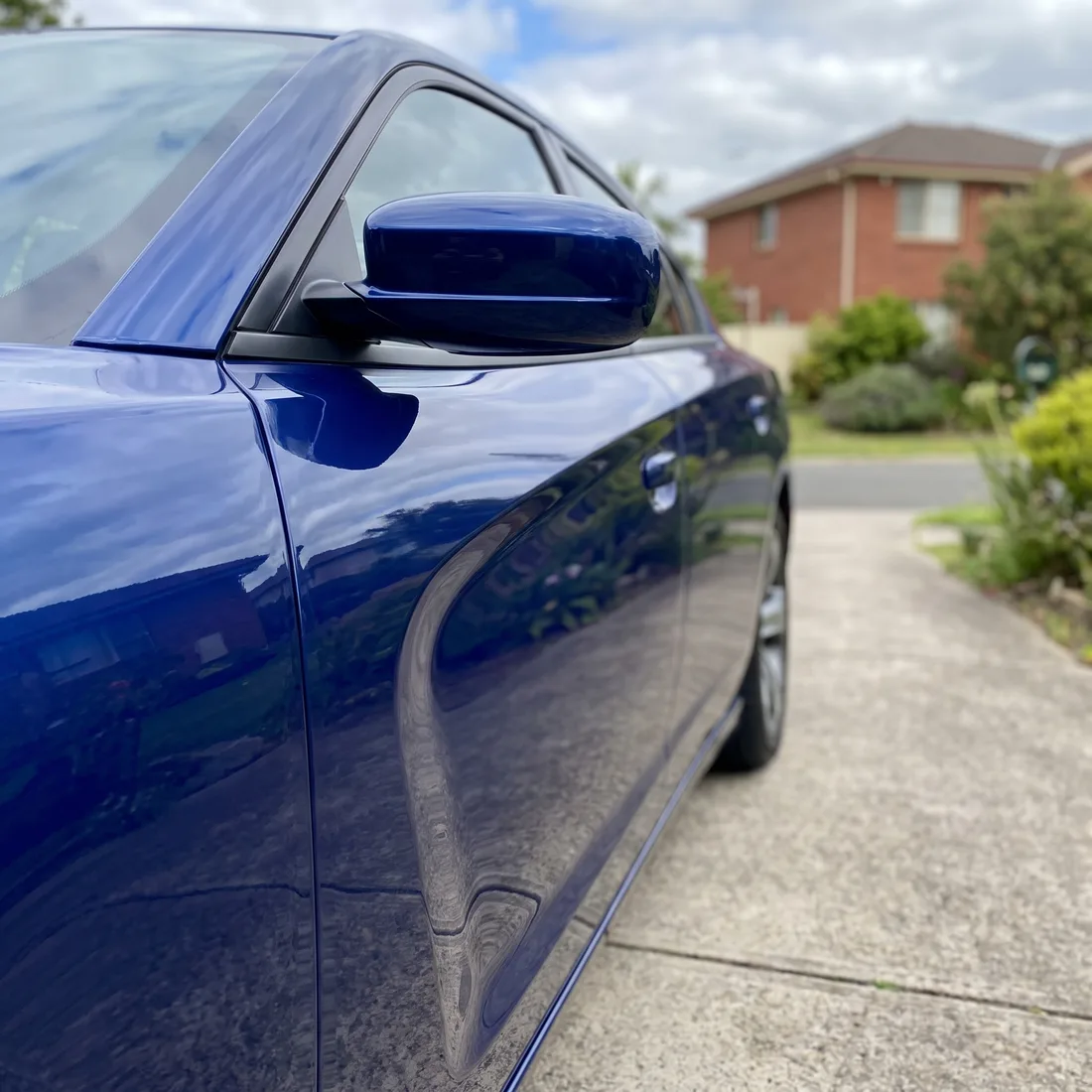 The door of a blue sedan after a mobile touch-up and polish